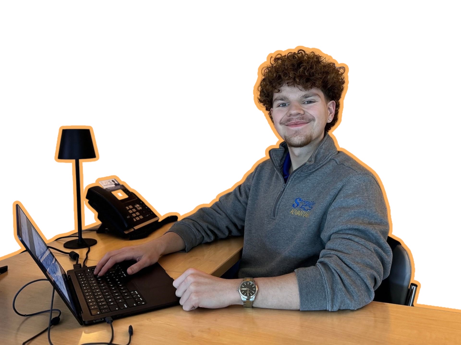 Andrew McLoone of Flowmingo Studios seated at his desk with a laptop